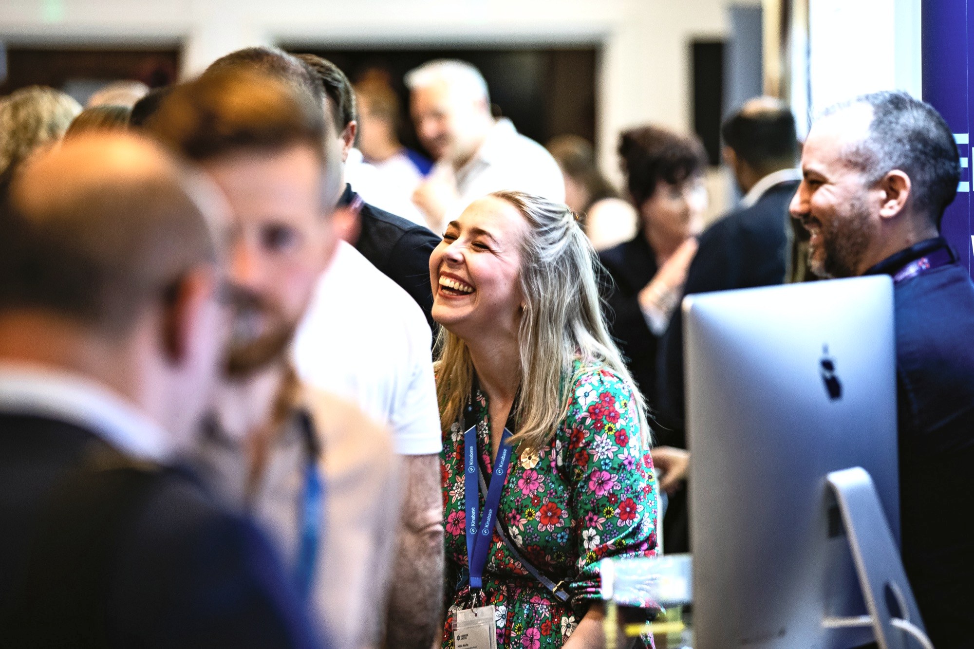 One of the team laughing with visitors at our stand at a business event