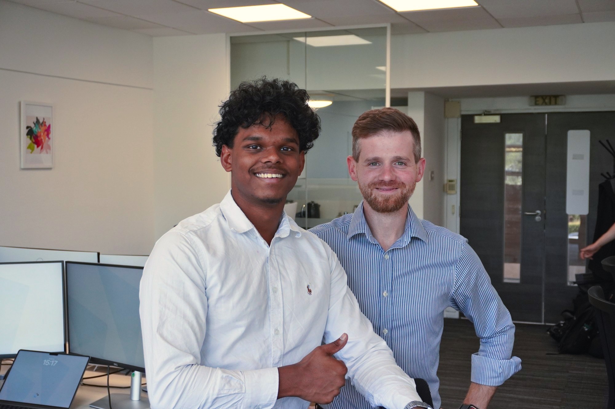 Two of the team smiling in the office