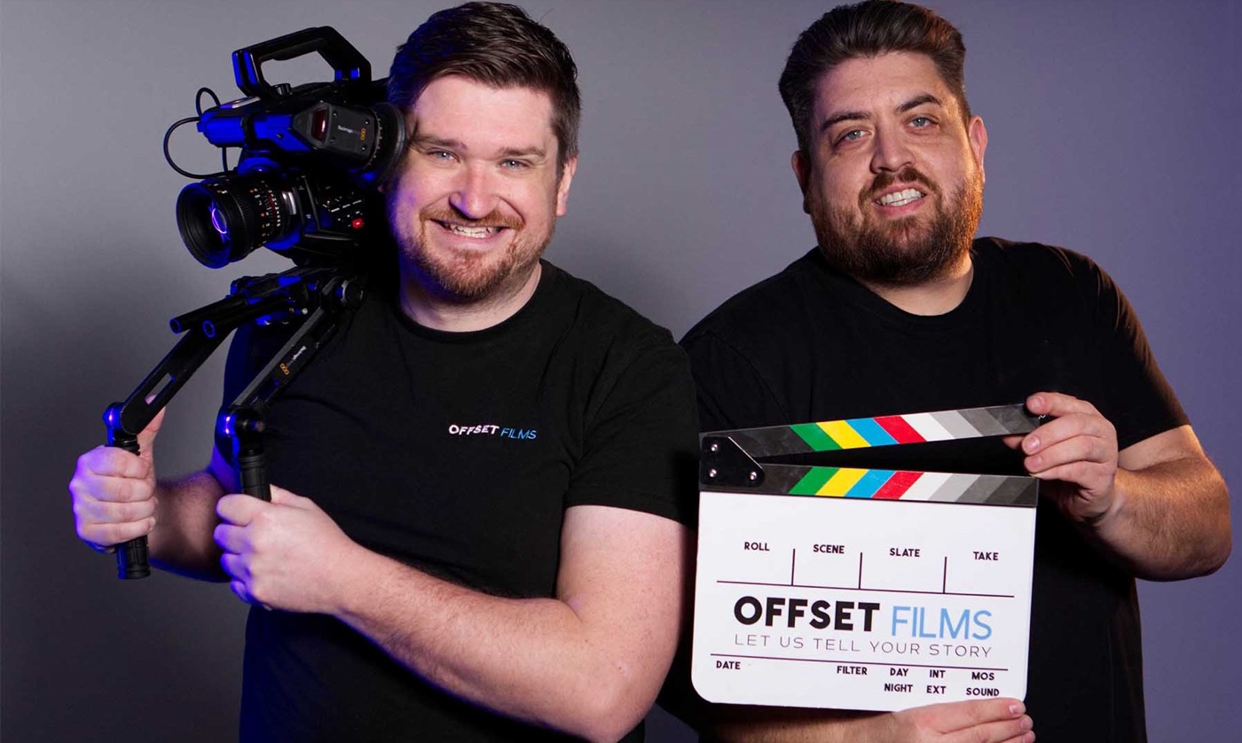 The two founders of Offset Films, one holding a cinema camera on a shoulder rig and the other a clapperboard with the Offset Films logo.