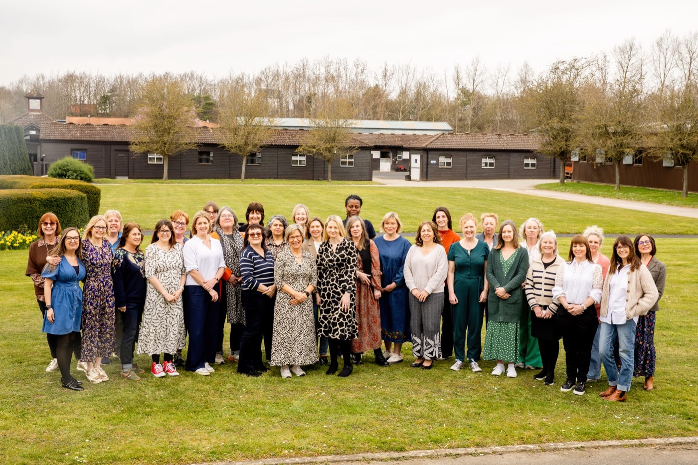 The Petals team, around forty people, standing together on a lawn in front of their offices.