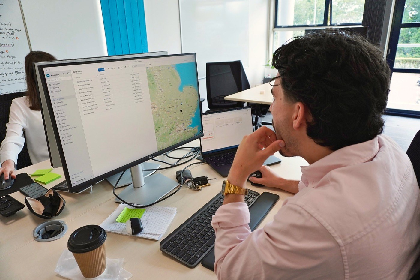 A member of our team at his desk, looking at a map of records on screen