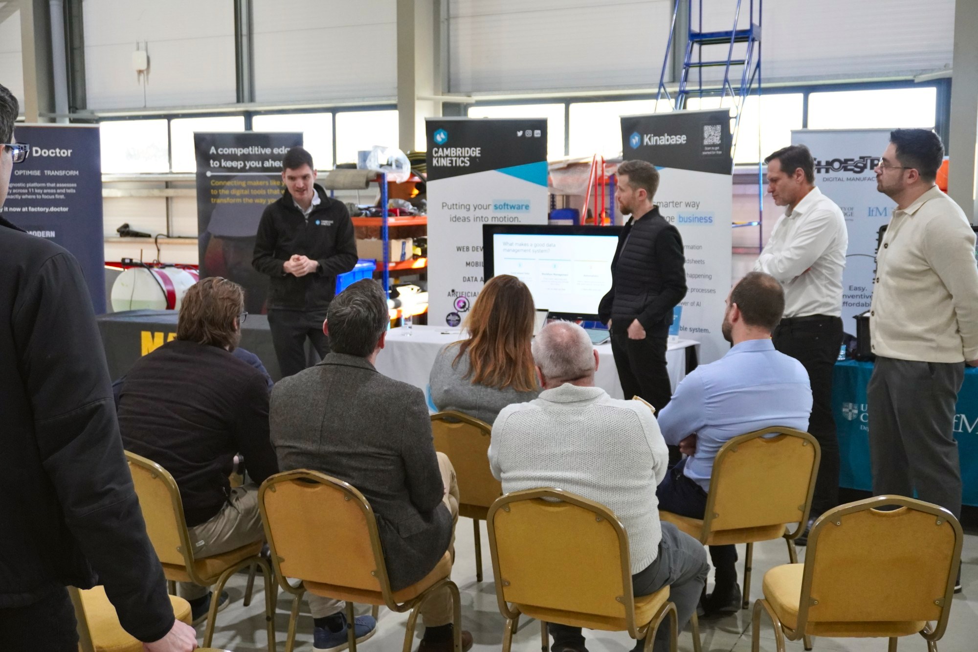 Two of our team talking a group through what makes a good data management system, at our stand at a manufacturing event