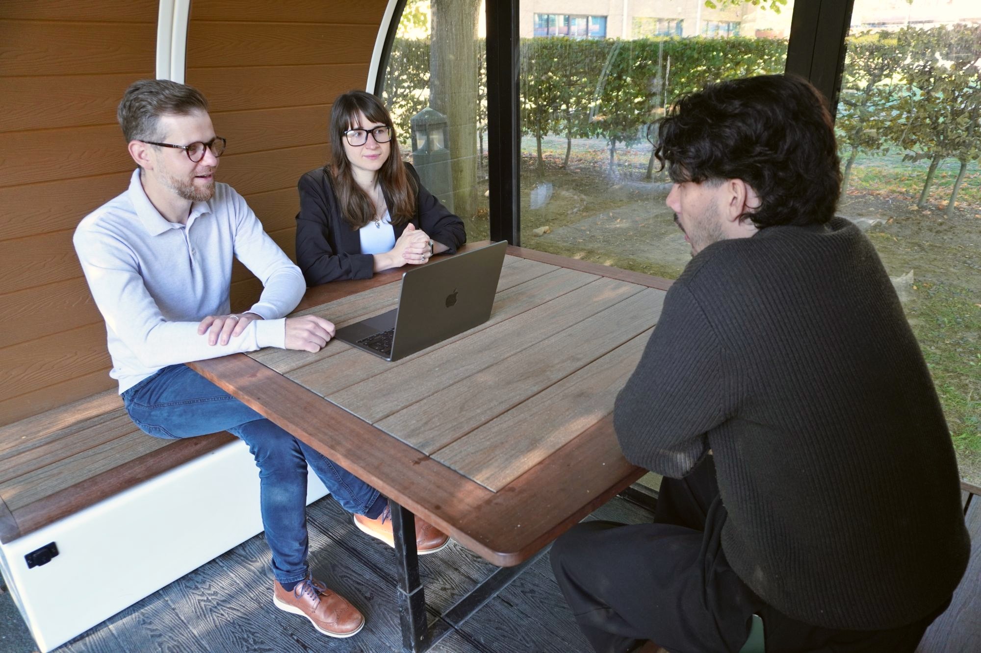 Two of our team talking a client through their system in a glass garden pod